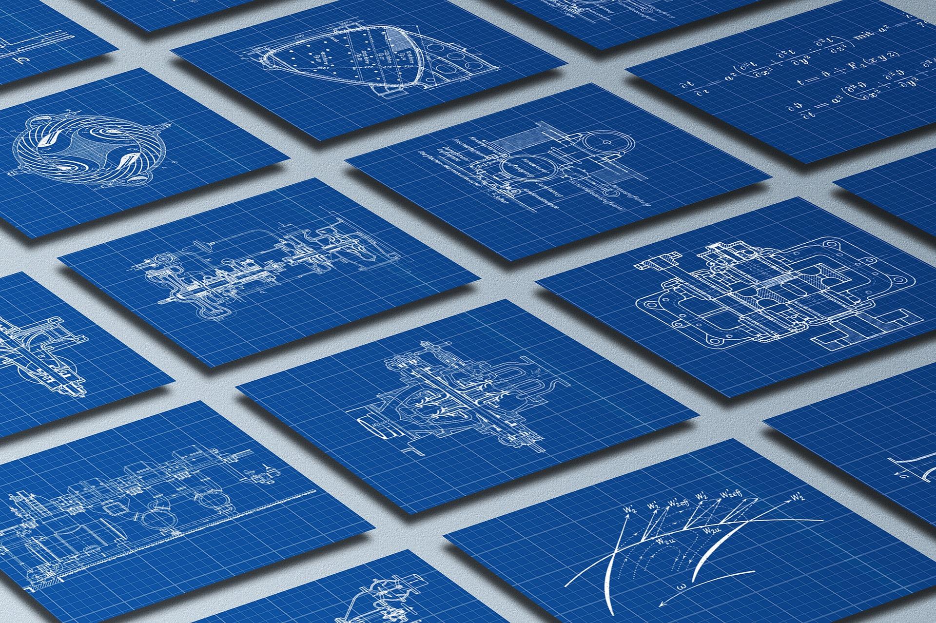 Mechanical engineering drawings on blue blueprint sheets